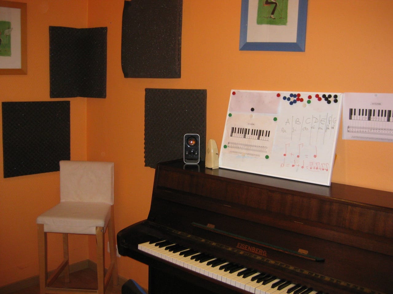 Un piano numérique et une méthode ouverte sur le pupitre, dans la salle de cours.